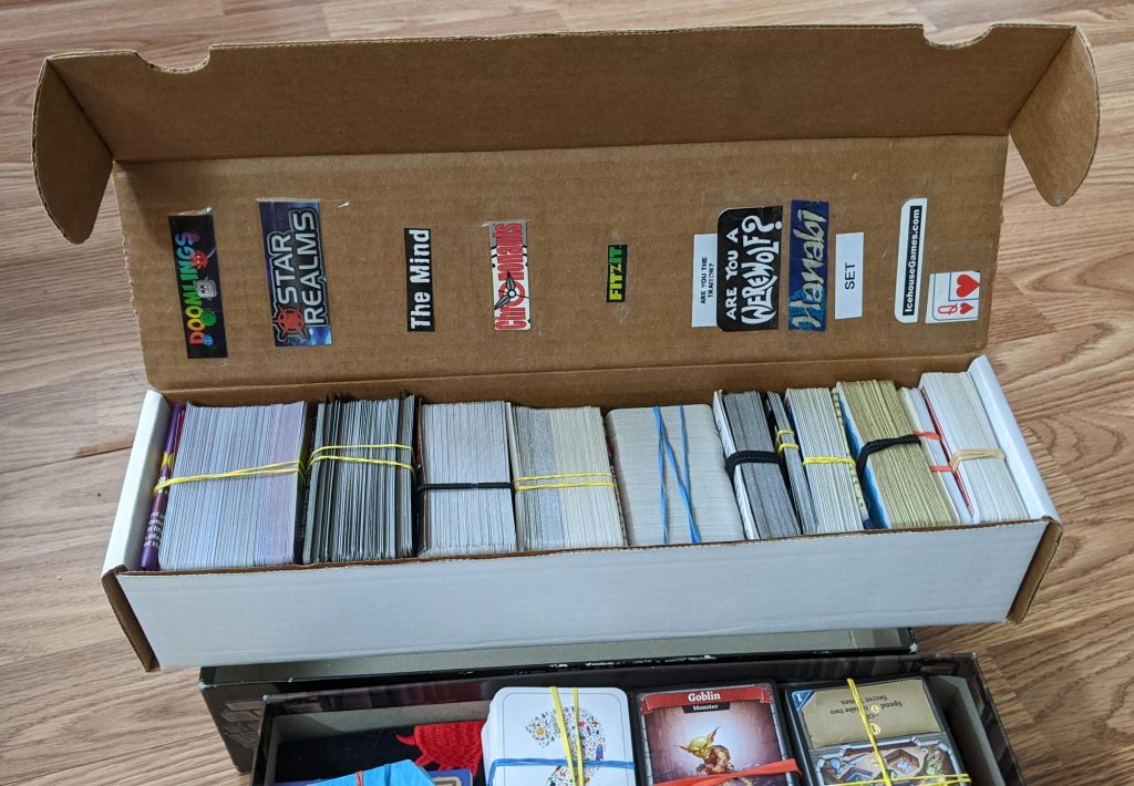 Left to right: Doomlings, Star Realms, The Mind, Chrononauts, FitzIt, Are you the traitor?, Are you a werewolf?, Hanabi, Set, Icehouse/Zendo rules, regular playing cards